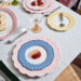 An array of colorful pastel plates with bold patterns creates a cheerful setting for a spring dinner party.